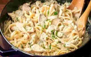 Nudeln mit Hähnchenbrust in einer cremigen Käsesauce serviert