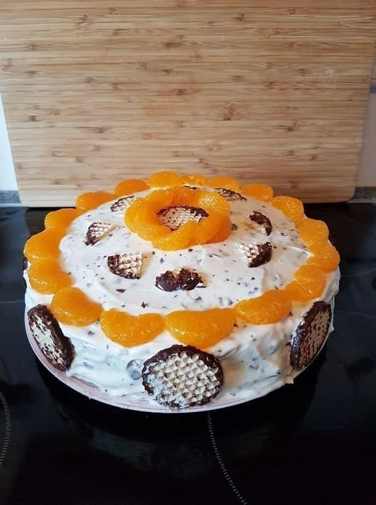 Schokokuss-Mandarinen-Torte mit einer Schokoladendecke und Mandarinenstücken
