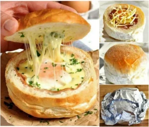 Frisches Ei-Schinken-Brötchen auf einem Teller, serviert mit frischem Salat.